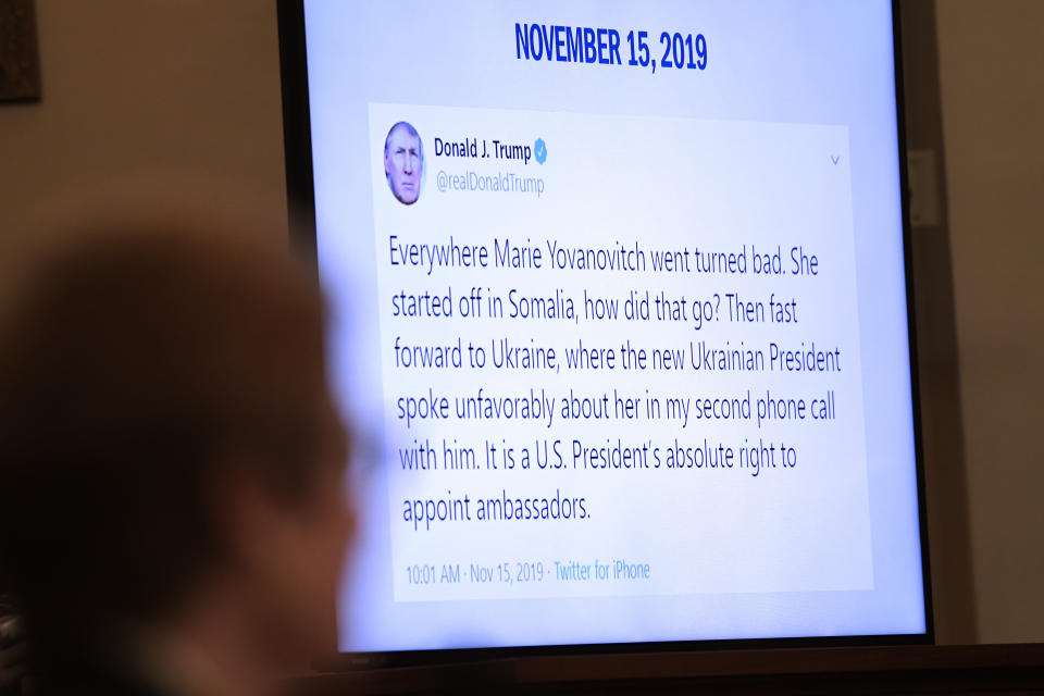 A Tweet from President Donald Trump is displayed on a monitor as former U.S. Ambassador to Ukraine Marie Yovanovitch, left, testifies before the House Intelligence Committee on Capitol Hill in Washington, Friday, Nov. 15, 2019, in the second public impeachment hearing of President Donald Trump's efforts to tie U.S. aid for Ukraine to investigations of his political opponents. (AP Photo/Susan Walsh)