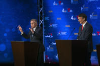 Virginia Democratic gubernatorial candidate and former Gov. Terry McAuliffe, left, and Republican challenger, Glenn Youngkin, participate in a debate at Northern Virginia Community College, in Alexandria, Va., Tuesday, Sept. 28, 2021. (AP Photo/Cliff Owen)