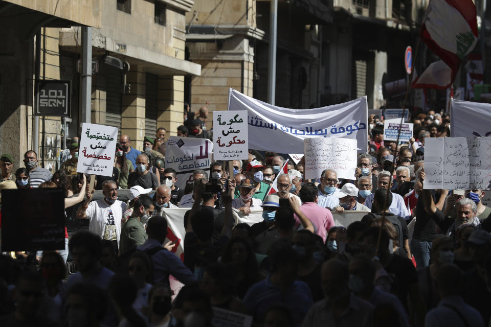 Anti-government protesters shout slogans against the government in Beirut, Lebanon, Saturday, June 13, 2020. Lebanese protesters took to the streets in Beirut and other cities in mostly peaceful gatherings against the government, calling for its resignation as the small country sinks deeper into economic distress. (AP Photo/Hassan Ammar)
