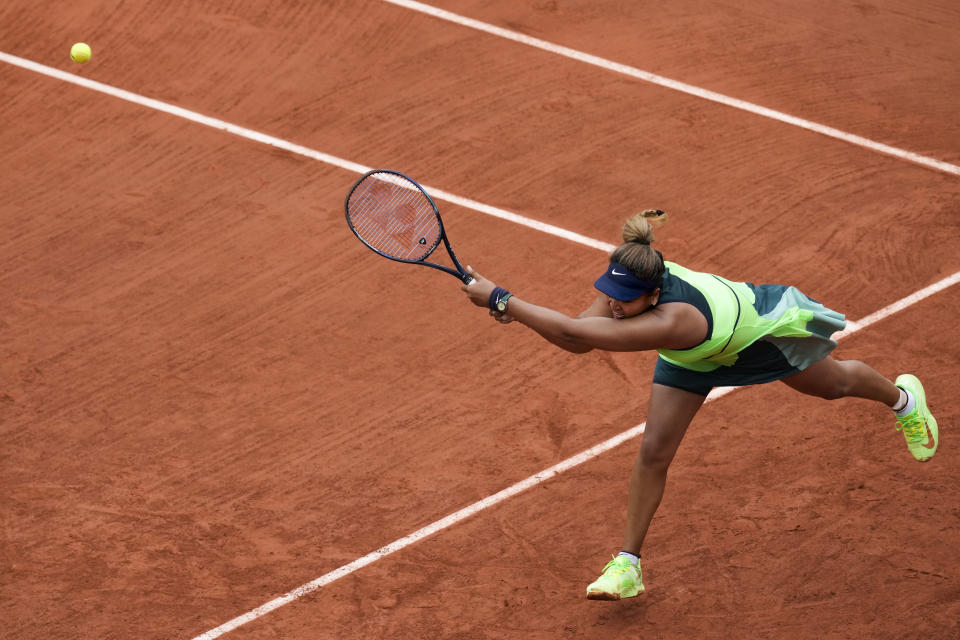 Japan's Naomi Osaka plays a shot against Amanda Anisimova of the U.S. during their first round match at the French Open tennis tournament in Roland Garros stadium in Paris, France, Monday, May 23, 2022. (AP Photo/Christophe Ena)