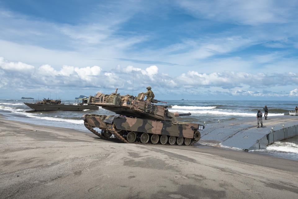 In this photo released by Australian Department of Defense via Australian Embassy in the Philippines, an Australian Army M1A1 Abrams Main Battle Tank from the 2nd Cavalry Regiment lands on the beach during a large-scale combined amphibious assault exercise on Friday, Aug. 25, 2023, at a naval base in San Antonio, Zambales, Philippines. The Philippines and Australia, while also backed by the United States Marine Corps, are holding a bilateral amphibious training called "Exercise Alon 2023," coined from Tagalog word meaning "wave," which is aimed at enhancing interoperability and preparedness to respond to security challenges in the Indo-Pacific region. (Riley Blennerhassett/Australian Department of Defense via AP)