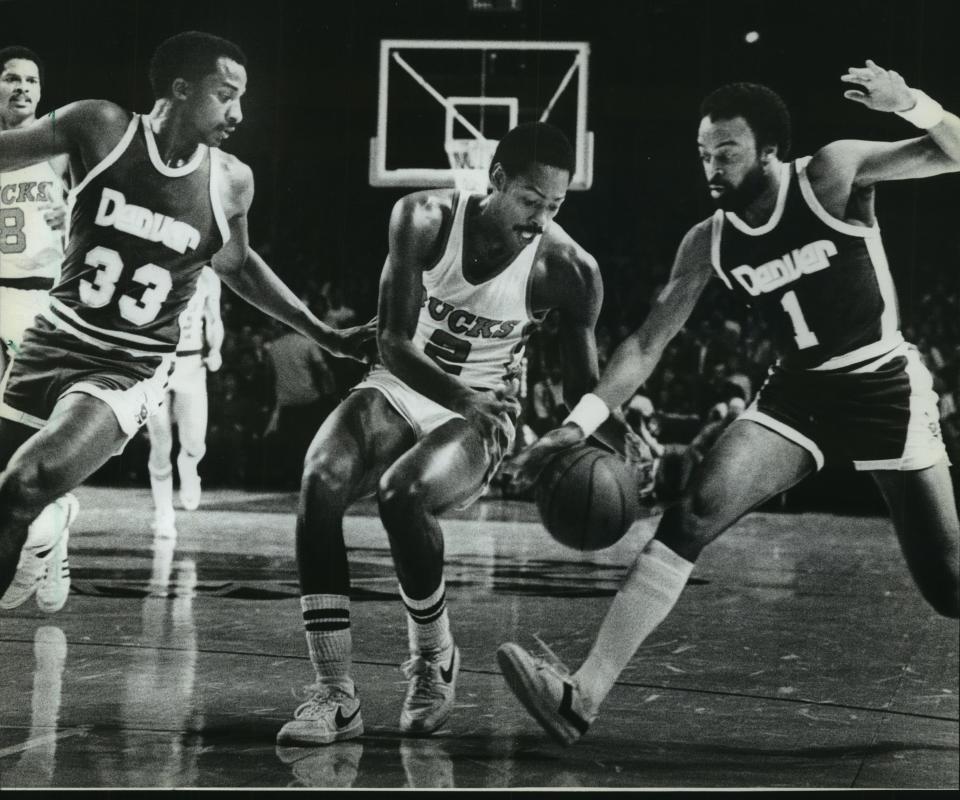 David Thompson (33) and Ken Higgs (1) of the Denver Nuggets battled Milwaukee's Junior Bridgeman for possession of the basketball during a game in 1982.