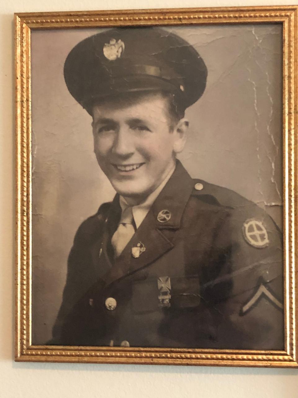 Bob Early’s military photo hangs on his apartment wall in Mishawaka. He was drafted in 1942 and served in Europe and was a prisoner of war for nine months near the end of the war.