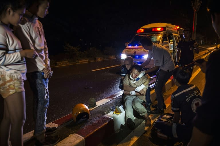 Vientiane Rescue volunteers help an injured motorcycle driver following a drink-driving accident in Laos