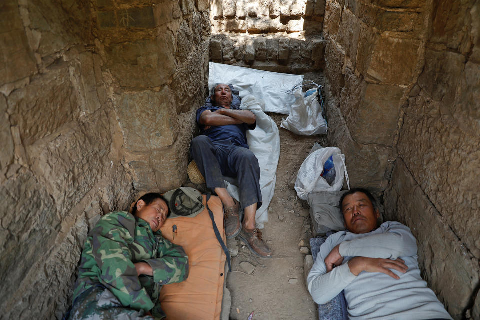 <p>People rest after working on the reconstruction of the Jiankou section of the Great Wall, located in Huairou District, north of Beijing, China, June 7, 2017. (Photo: Damir Sagolj/Reuters) </p>