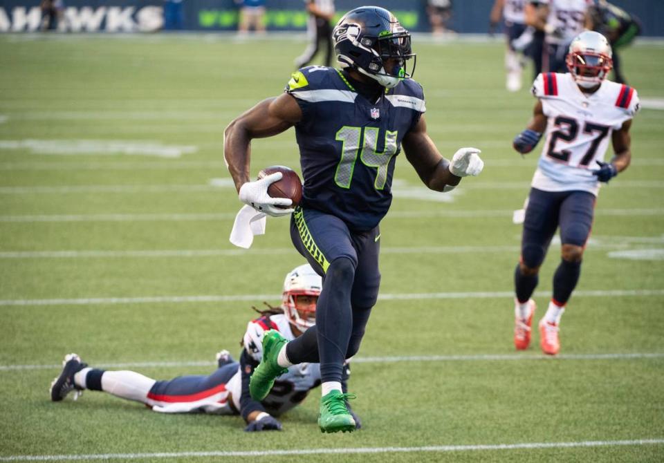 Seattle Seahawks wide receiver DK Metcalf (14) makes a catch for a touchdown while defended by New England Patriots cornerback Stephon Gilmore (24) during the second quarter. The Seattle Seahawks played the New England Patriots in a NFL football game at CenturyLink Field in Seattle, Wash., on Sunday, Sept. 20, 2020.