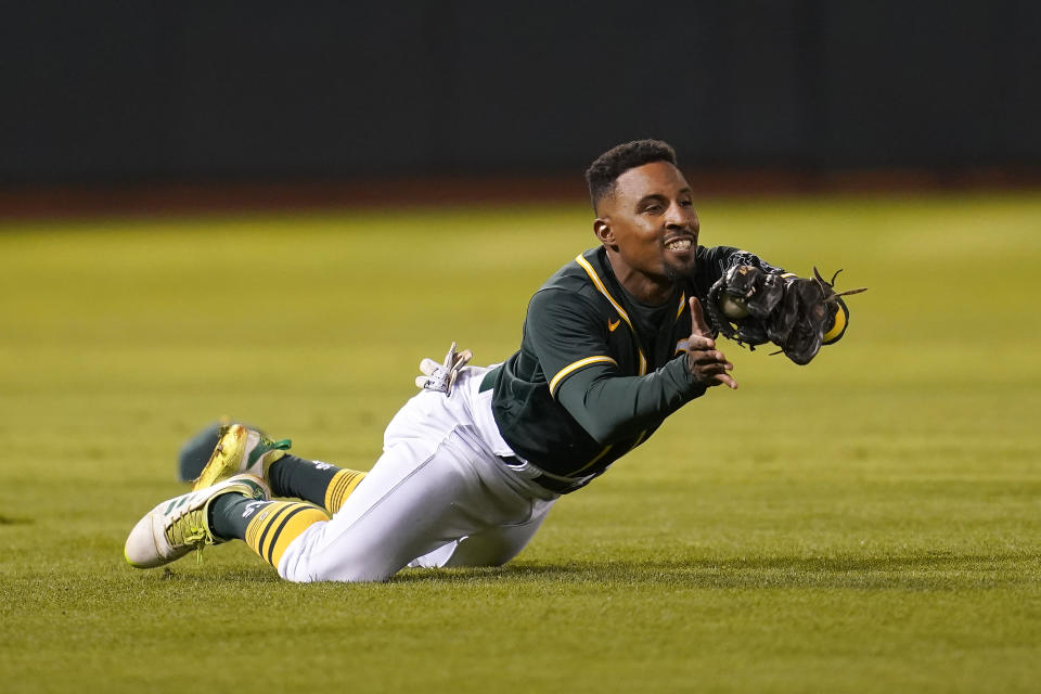 Oakland Athletics left fielder Tony Kemp catches a lineout hit by Seattle Mariners' Jarred Kelenic during the eighth inning of a baseball game in Oakland, Calif., Wednesday, Sept. 22, 2021. (AP Photo/Jeff Chiu)