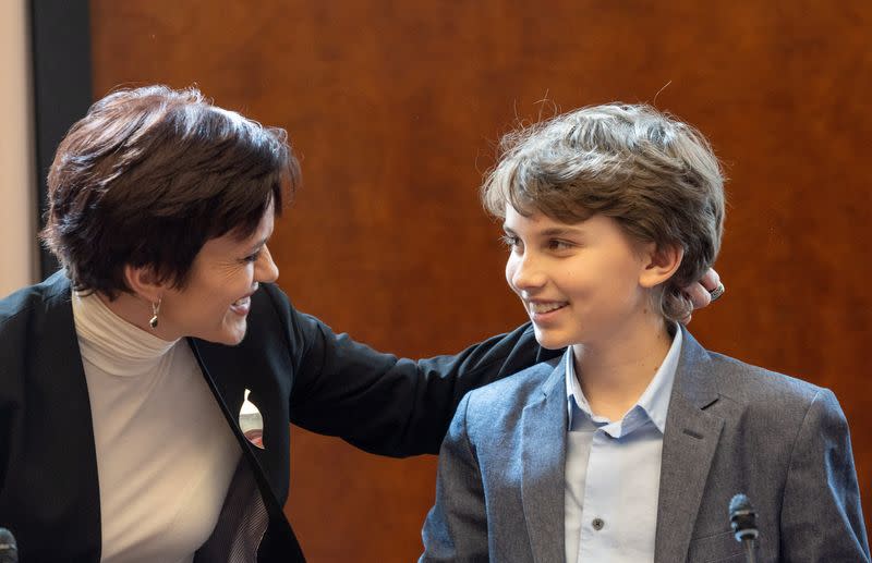 Human rights activist and wife of prisoner Vladimir Kara-Murza, Evgenia Kara-Murza talks with her son Daniil after attending an ACANU briefing in Geneva