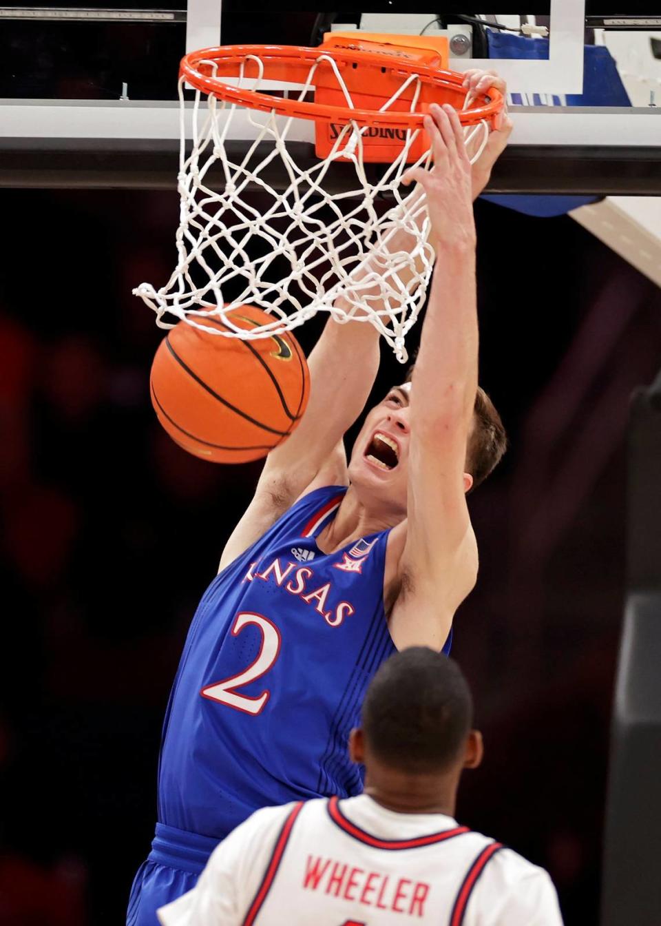 Kansas guard Christian Braun dunks against St. John’s during a December game in Elmont, N.Y.