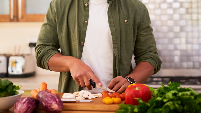 person slicing veggies