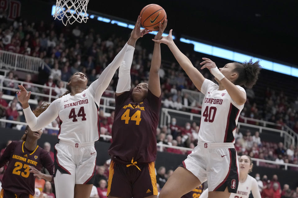 Arizona State guard Isadora Sousa, middle, grabs a rebound between Stanford forward Kiki Iriafen, left, and forward Courtney Ogden (40) during the first half of an NCAA college basketball game in Stanford, Calif., Sunday, Feb. 25, 2024. (AP Photo/Jeff Chiu)