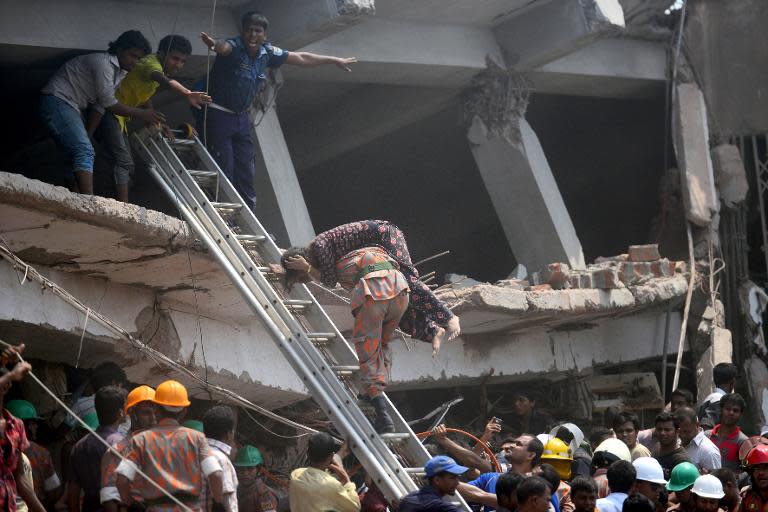 A Bangladeshi firefighter carries an injured garment worker from the collapsed Rana Plaza building in Savar, on the outskirts of Dhaka, April 24, 2013