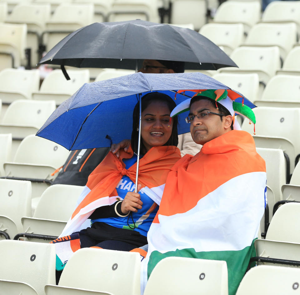 Indian fans shelter under umbrellas during the ICC Champions Trophy Final at Edgbaston, Birmingham.