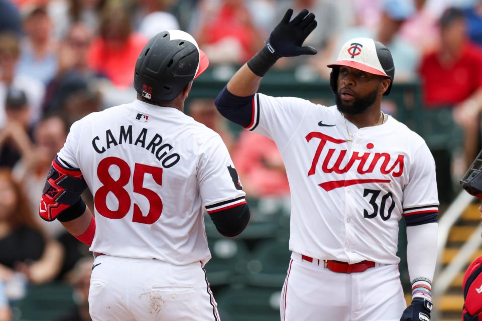 Minnesota Twins catcher Jair Camargo (85) is congratulated by first baseman Carlos Santana (30) after hitting a two run home run against the Boston Red Sox in the fourth inning at Hammond Stadium during spring training.