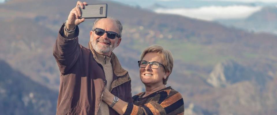 happy spain senior couple hiking in the nature