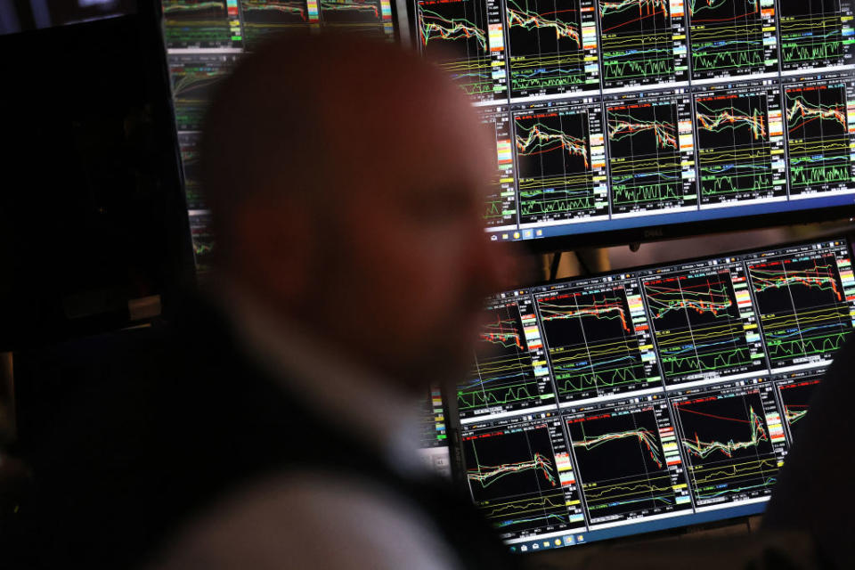 A screen of stock charts on the floor of the New York Stock Exchange.