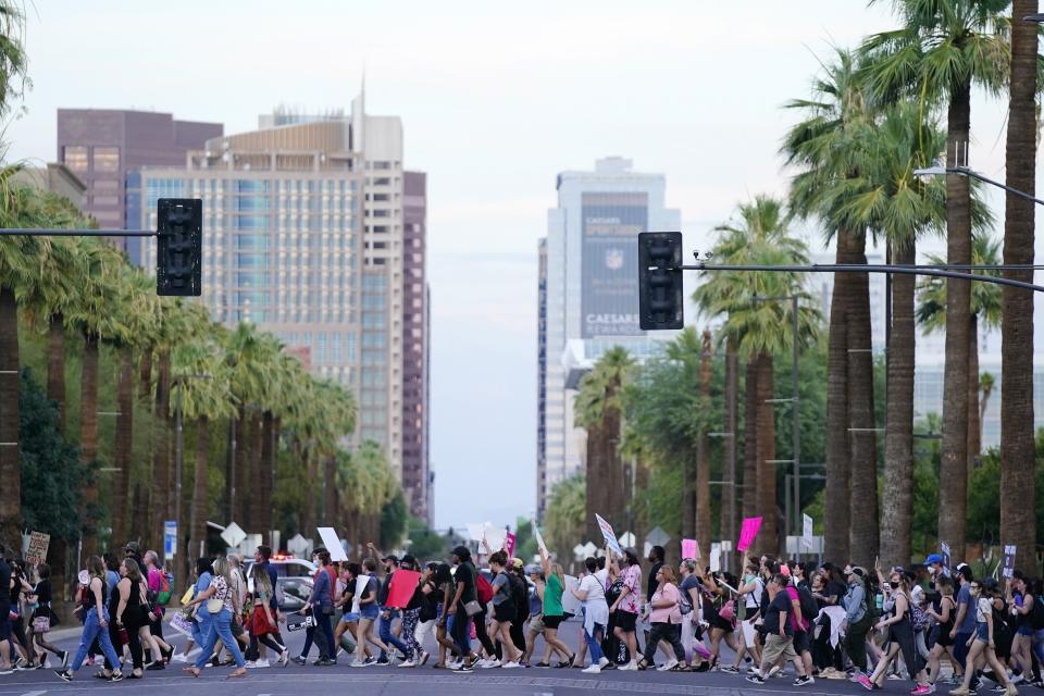 Protesters march near downtown Phoenix after the Supreme Court overturned Roe v. Wade, Friday, June 24, 2022. The U.S. Supreme Court's decision to end constitutional protections for abortion has cleared the way for states to impose bans and restrictions on abortion — and will set off a series of legal battles. (AP Photo/Ross D. Franklin)