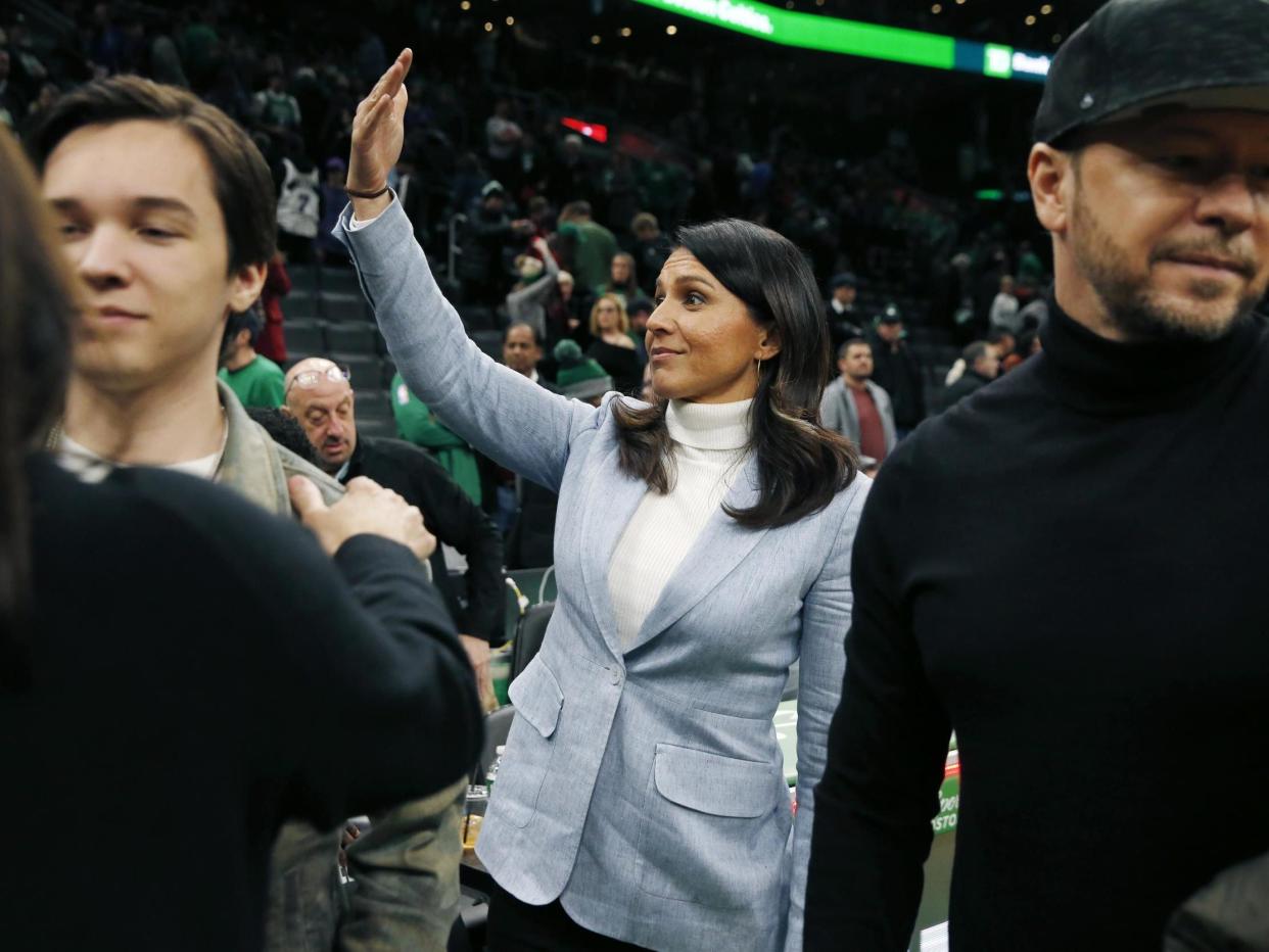 Presidential candidate, U.S. Rep. Tulsi Gabbard, D-Hawaii, center, gestures following an NBA basketball game between the Boston Celtics and the Toronto Raptors: AP