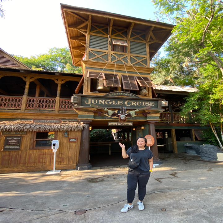 Me standing outside the entrance of the ride, which has a Jungle Cruise sign