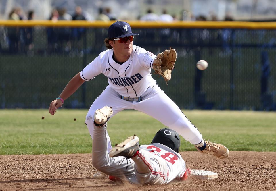 American Fork’s Daxton Greening (28) slides back to the base before getting tagged by Westlake’s (6) Drew Smith at Westlake High in Saratoga Springs on Thursday, April 27, 2023. | Laura Seitz, Deseret News