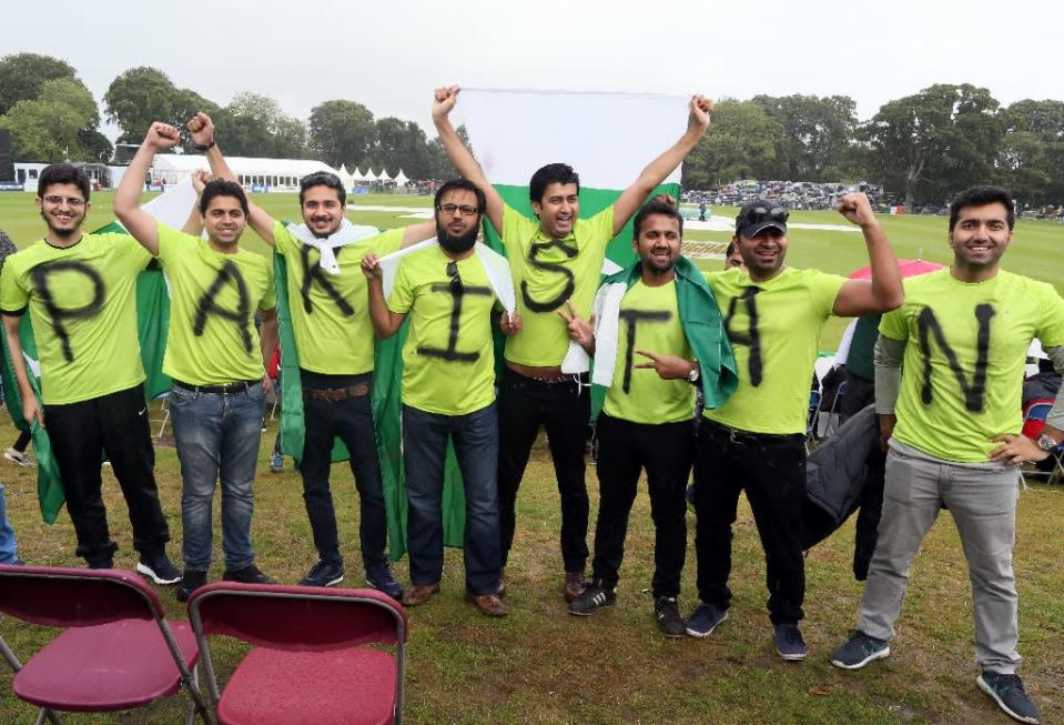 Pakistan supporters pose as wind and rain cancels play during the second one day international cricket match between Ireland and Pakistan at the Malahide stadium in Dublin on August 20, 2016 (AFP Photo/Paul Faith)