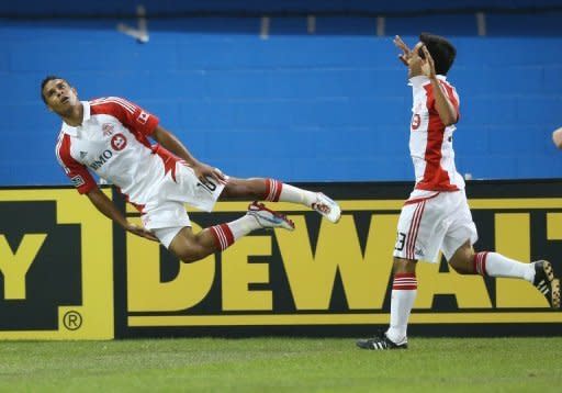 Quincy Amarikwa (L) of Toronto FC celebrates his goal with Sergio Camargo against Liverpool during the World Football Challenge friendly match at Rogers Centre in Toronto. The match ended in a 1-1 draw