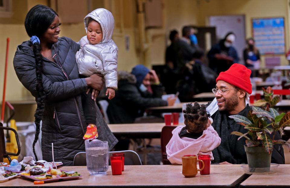 Nyrie Melendez,  24, left, holds daughter,  Nigeria Melendez, 2, while Nivario Grice, 39, right, holds their other daughter Arcanoah Grice, 1.  Nivario Grice is in school to become a teacher. He is hopeful they will find stable housing soon. “Everything else ain’t so bad, so I feel like maybe something good’s coming.”