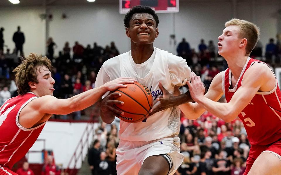 Brownsburg forward Kanon Catchings is fouled as he looks to score against New Palestine in the Southport Regional on Saturday, March 11, 2023.