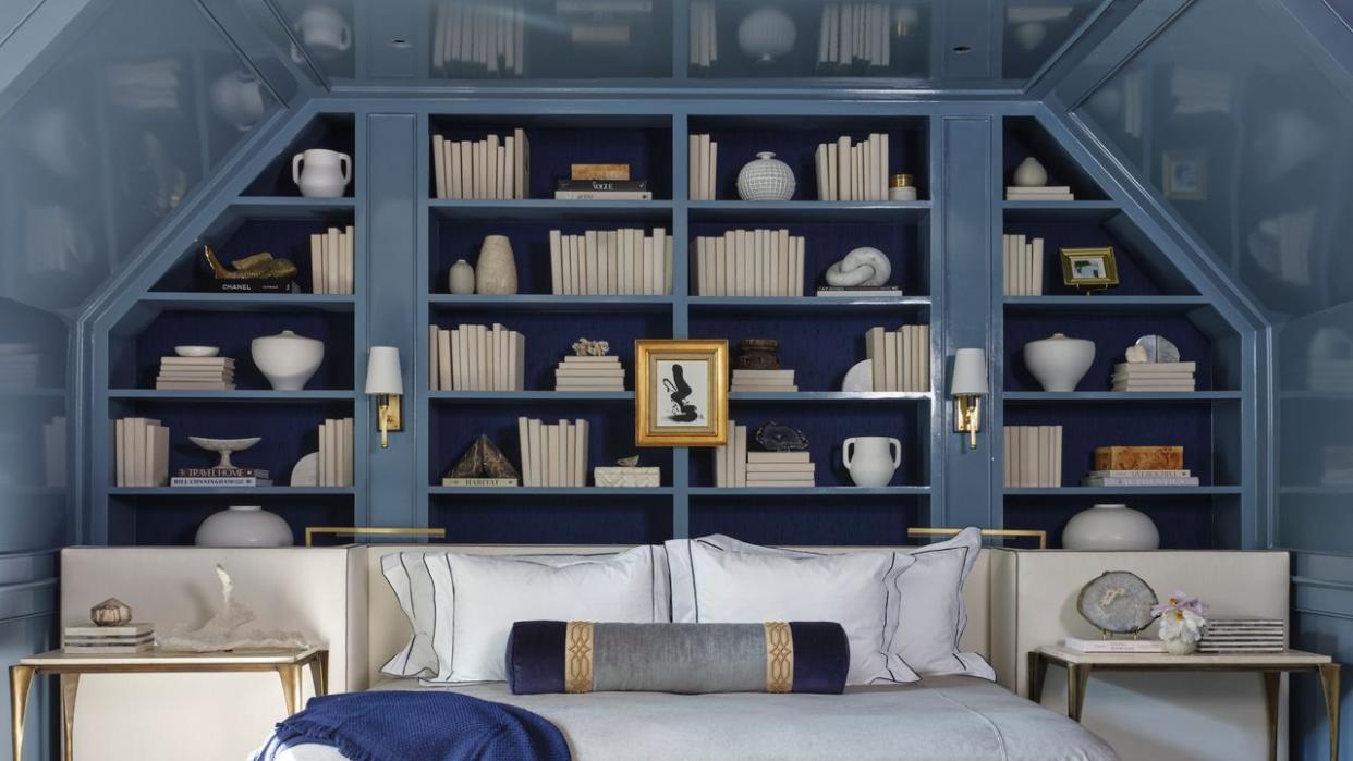 a room with a bed and shelves