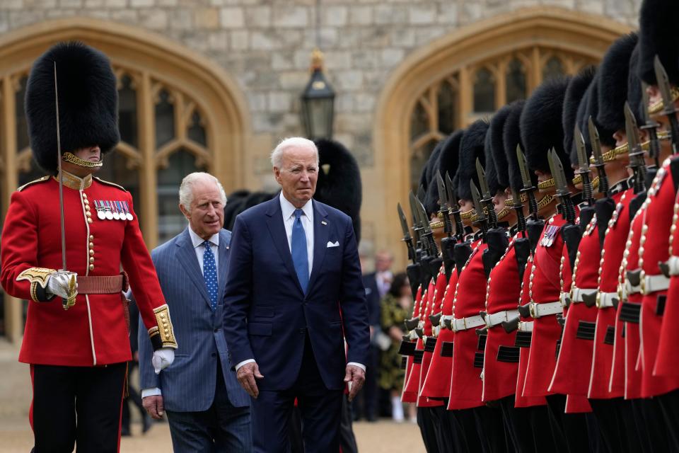President Joe Biden reviews royal guards along with Britain's King Charles III during a welcoming ceremony at Windsor Castle in Windsor, England, Monday, July 10, 2023.