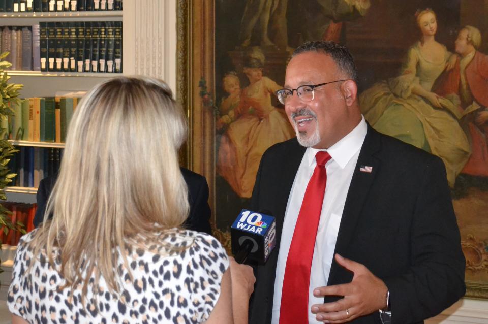 U.S. Secretary of Education Dr. Miguel Cardona speaks to a reporter after a celebration of the 50th anniversary of the Pell Grant Monday at Salve Regina University.