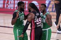 Boston Celtics' Jaylen Brown, left, and Miami Heat's Jae Crowder (99) exchange words as Kemba Walker (8) attempts to calm the situation during the second half of an NBA conference final playoff basketball game, Saturday, Sept. 19, 2020, in Lake Buena Vista, Fla. (AP Photo/Mark J. Terrill)