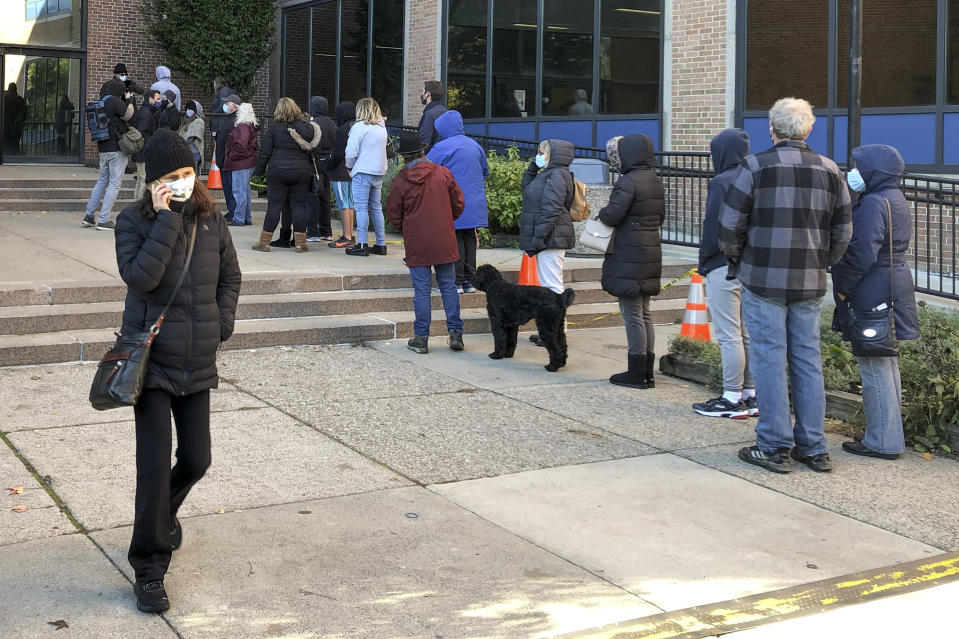 Voters wait in line outside the Bucks county government building in Doylestown, Pa., a suburb of Philadelphia, on Monday, Nov. 2, 2020. Some said they received word that their mail-in ballots had problems and needed to be fixed in order to count. (AP Photo/Mike Catalini)