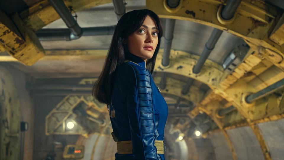 Lucy MacLean (Ella Purnell) in her blue and yello Vault Suit inside Vault 33 in the Fallout TV show.