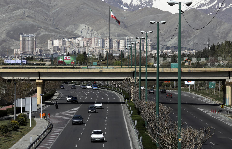 Cars drive in a highway in northern Tehran, Iran, Friday, March 20, 2020, on the first day of Iranian New Year, called Nowruz, or "New Day" in Farsi, the Persian holiday marking the the spring equinox. The new coronavirus has cut into the ancient Nowruz and has further slowed the Islamic Republic's economy. (AP Photo/Vahid Salemi)