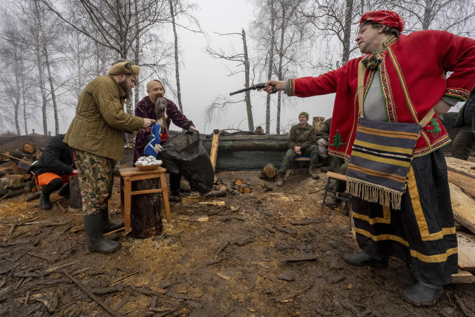 A group of artists perform for Ukraine's National Guard soldiers to mark Christmas at their positions close to the Russian border near Kharkiv, Ukraine, Saturday Dec. 24, 2022. (AP Photo/Andrii Marienko)