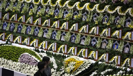 Mourners look at the portraits of victims onboard capsized passenger ship Sewol at a temporary group memorial altar in Ansan April 24, 2014. REUTERS/Kim Hong-Ji