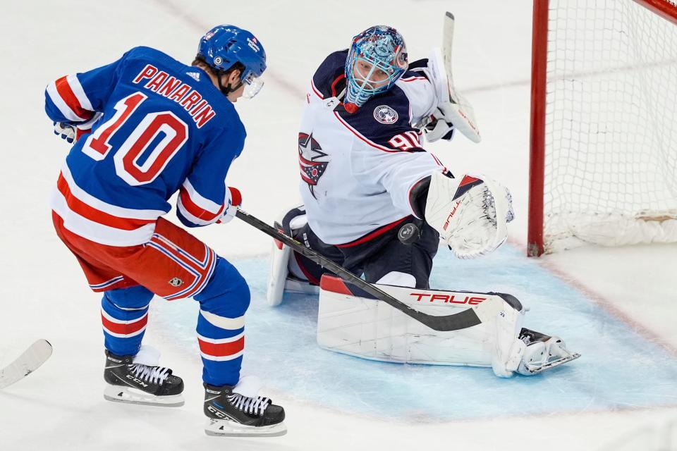 Columbus Blue Jackets goaltender Elvis Merzlikins (90) stops a shot by New York Rangers' Artemi Panarin (10) during the third period of an NHL hockey game Wednesday, Feb. 28, 2024, in New York. (AP Photo/Frank Franklin II)