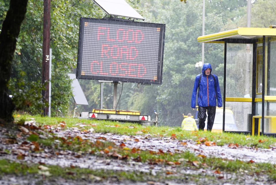 A man walks past a flood sign in Liverpool. Heavy rain is set to continue as two new weather warnings come into force on Monday, potentially leading to further flooding and travel disruption. Picture date: Monday, September 30, 2024. (Photo: Peter Byrne/PA Images via Getty Images)