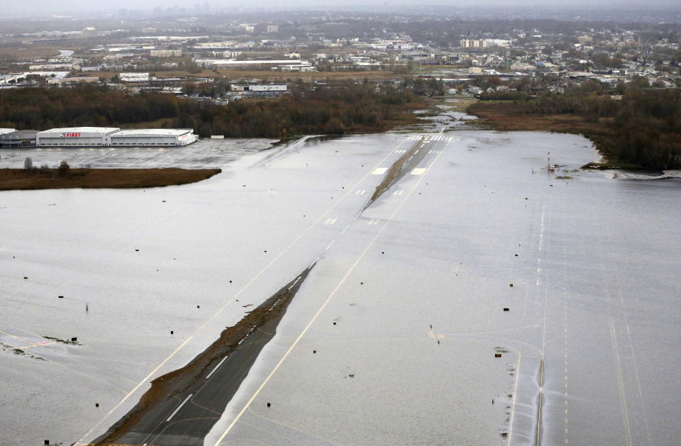 A runway at the Teterboro Airport is flooded in the wake of superstorm Sandy on Tuesday, Oct. 30, 2012, in New York. Sandy, the storm that made landfall Monday, caused multiple fatalities, halted mass transit and cut power to more than 6 million homes and businesses. (AP Photo/Mike Groll)