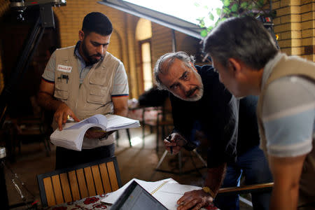 Director Hassan Husni speaks to the director of photography while filming Òthe hotelÓ TV series, which is being filmed and broadcast during the Muslim holy month of Ramadan, in Baghdad, Iraq May 12, 2019. Picture taken May 12, 2019. REUTERS/Thaier al-Sudani