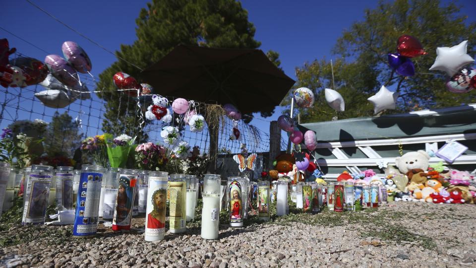 A makeshift memorial grows in front of the home where Rachel Henry was arrested on suspicion of killing her three children after they were found dead inside the family home earlier in the week, shown here Thursday, Jan. 23, 2020, in Phoenix. (AP Photo/Ross D. Franklin)