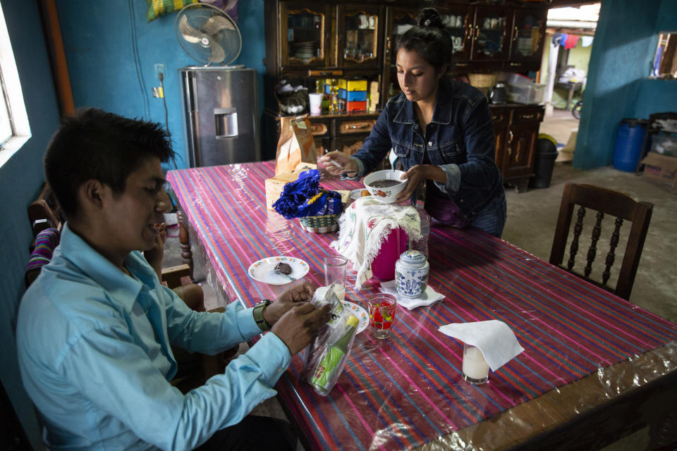 Teacher Gerardo Ixcoy and his wife Yessika Lopez prepare to have lunch in their home in Santa Cruz del Quiche, Guatemala, Wednesday, July 15, 2020. "One day the mother of a student told me they didn't have food," Ixcoy said. "When class ended and I began to ride away on my tricycle she calls me and with a look of gratefulness says, 'Teacher, they gave me some food, I want to share half with you.'" (AP Photo/Moises Castillo)
