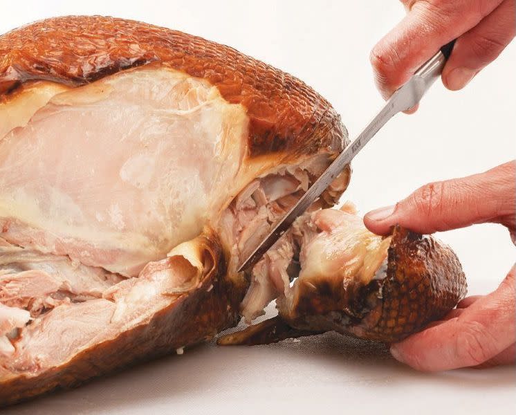Cut all the way through the joint, through any meat and skin, and remove the wing from the carcass.