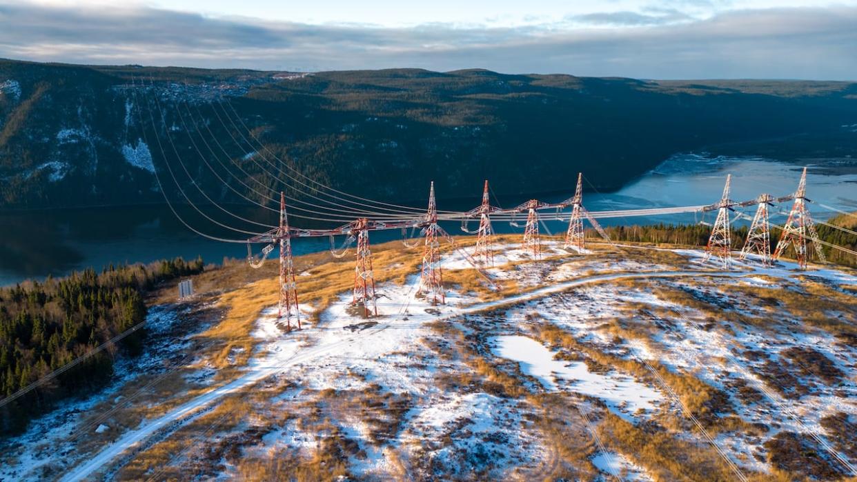 High-voltage wires carry 90 per cent of the electricity produced at the Churchill Falls dam toward the Quebec-Labrador border, some 200 kilometres to the south. (Danny Arsenault/CBC - image credit)