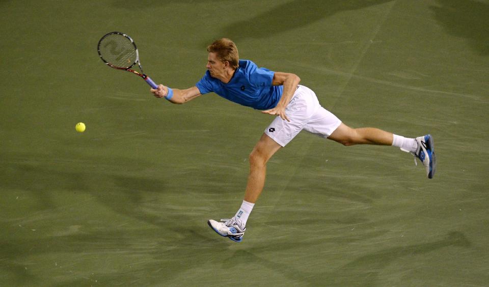 Kevin Anderson, of South Africa, returns a shot to Roger Federer, of Switzerland, during the quarterfinals of the BNP Paribas Open tennis tournament, Thursday, March 13, 2014, in Indian Wells, Calif. (AP Photo/Mark J. Terrill)