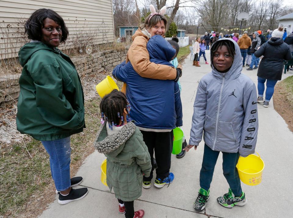 Kathy Hocevar, center, greets a family to the annual Hocevar family Easter egg hunt, Saturday, April 16, 2022, in Sheboygan Falls, Wis. According to Hocevar the family had to postpone the event for the last two years because of the COVID pandemic.