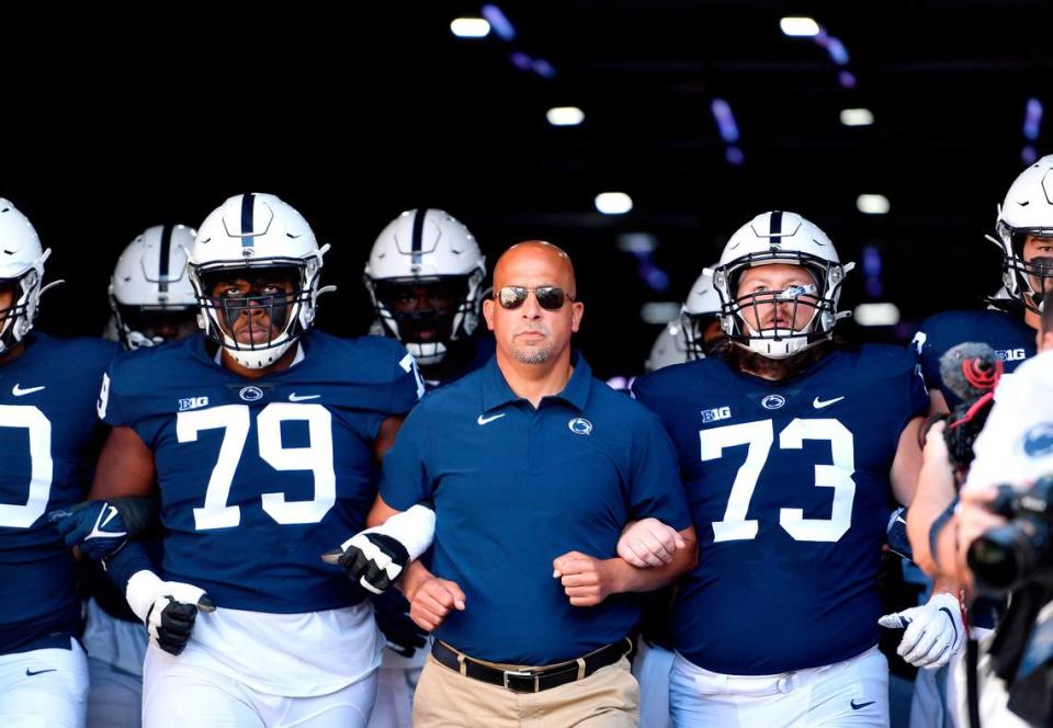 Penn State offensive linemen Caedan Wallace (left) and Mike Miranda link arms with coach James Franklin to walk out of the tunnel for the game against Ball State on Saturday, Sept. 11, 2021. Abby Drey/adrey@centredaily.com