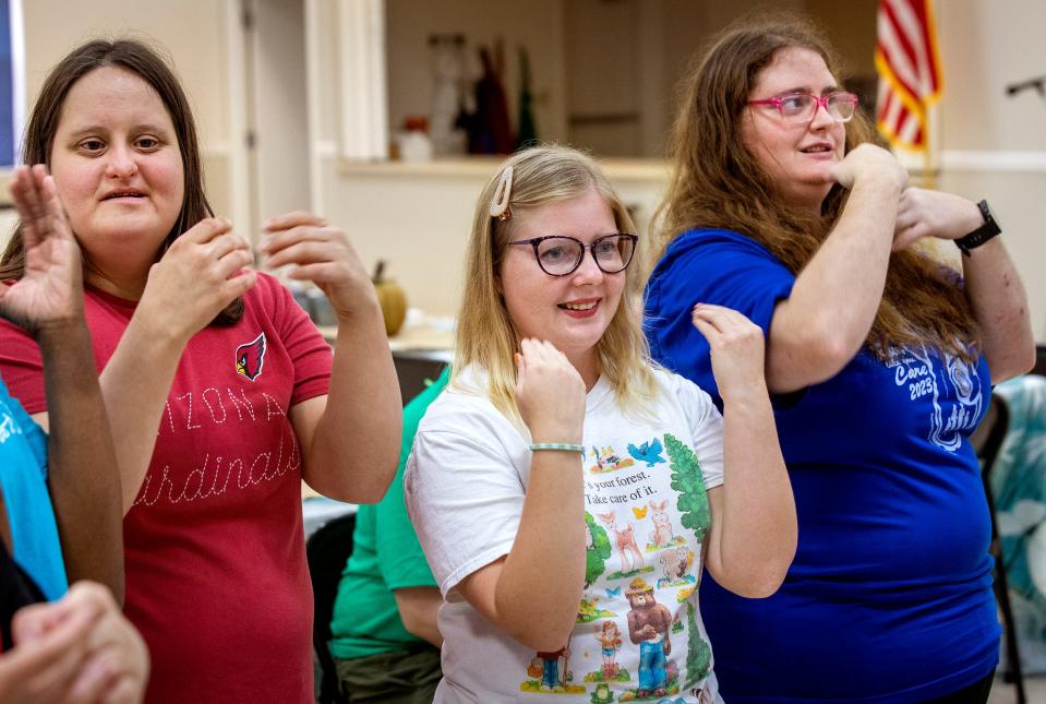 Erin Brown, left, Lana Gomez and Katie Odom sing the Circle Of Friends song on a recent afternoon at the facility in Lake Wales. Circle of Friends Ministry, a nonprofit founded in 1999, that provides programs for adults with intellectual and developmental disabilities.