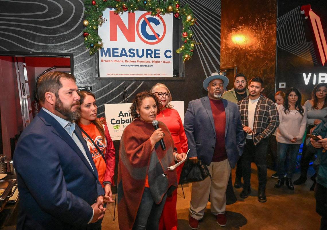 Sandra Celedon, CEO of Fresno Building Healthy Communities, speaks to a large group including California Assemblymember Joaquin Arambula, left, opposing the renewal of Measure C during a election night watch party at Vibez Lounge in Fresno’s Tower District on Tuesday, Nov. 8, 2022.